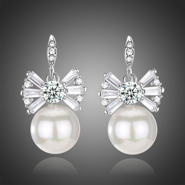 KHAISTA pearl bow knot drop earrings on white background