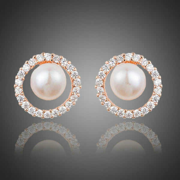 KHAISTA pearl eyeball stud earrings on white background