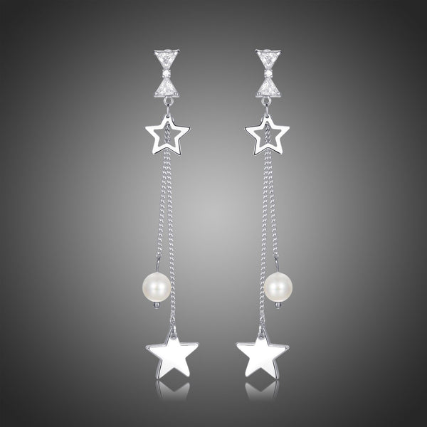 KHAISTA clear CZ pearl pentagram drop earrings on white background