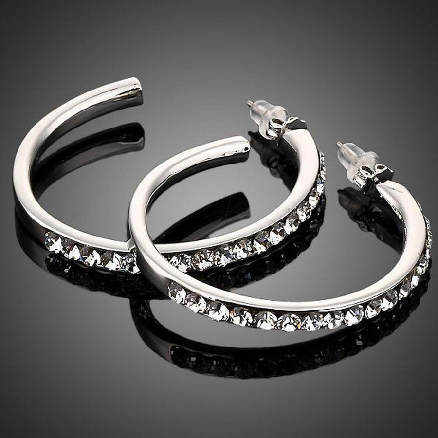 KHAISTA platinum plated bangle design drop earrings on white background