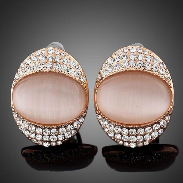 KHAISTA crystal popping eye stud earrings on white background