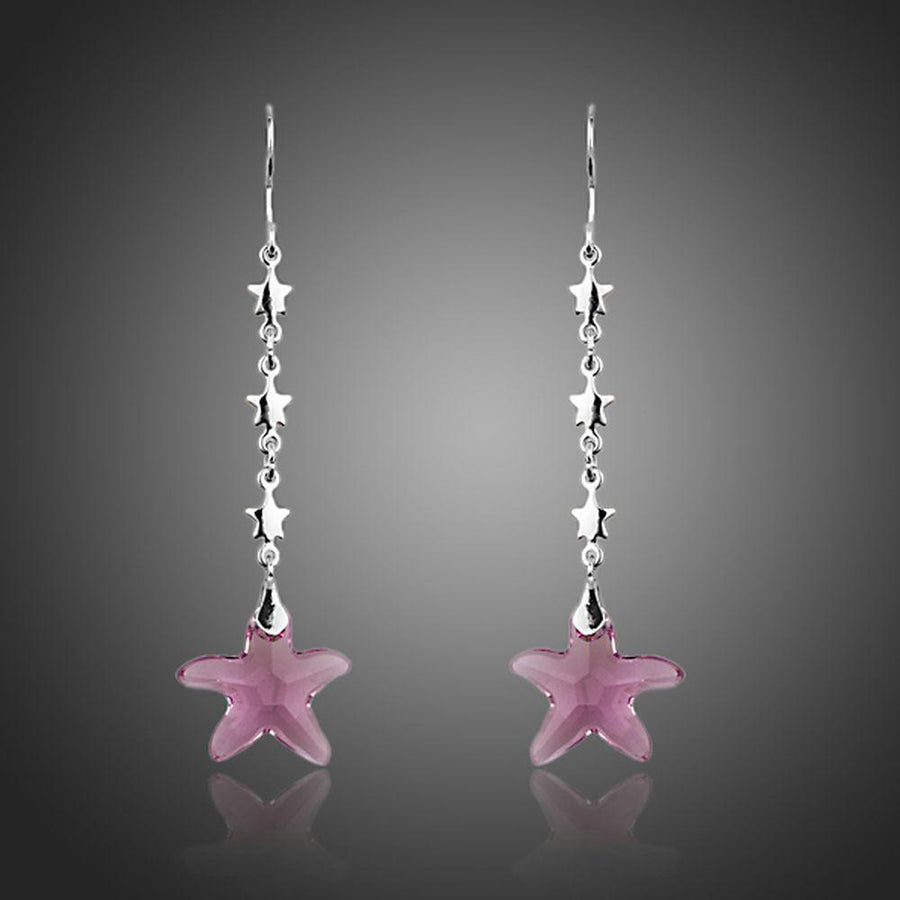 KHAISTA purple crystal star drop earrings on white background