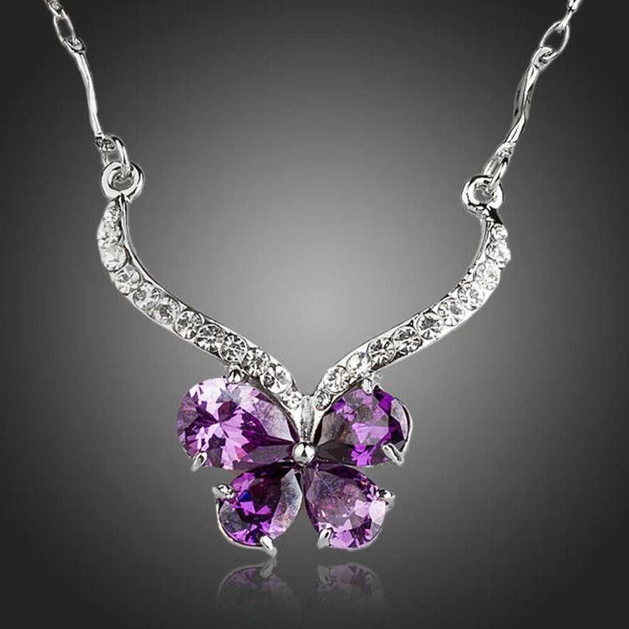 KHAISTA purple CZ butterfly pendant necklace on white background