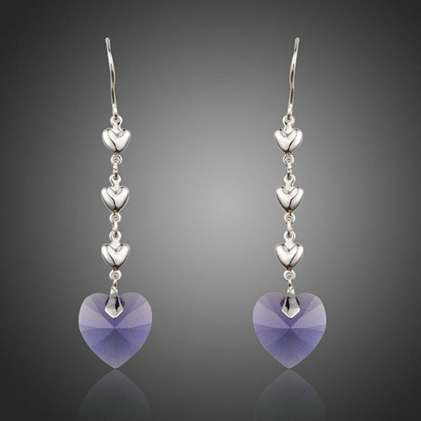 KHAISTA purple heart design crystal drop earrings on white background