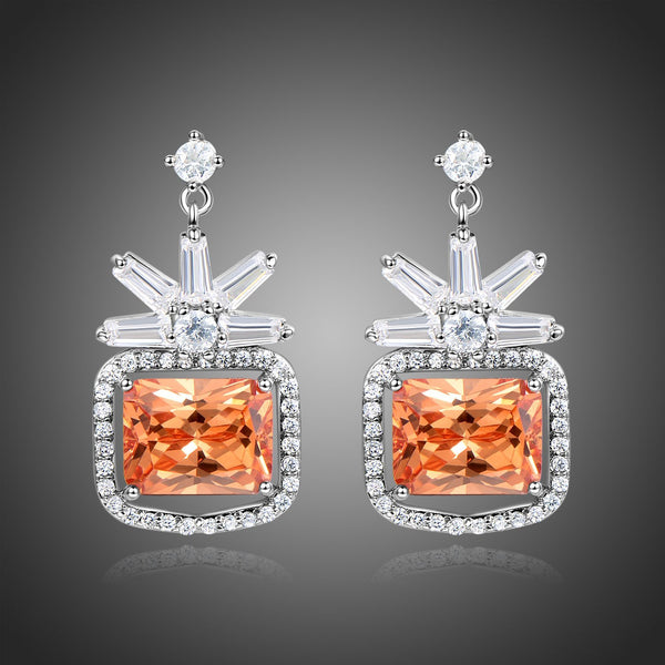 KHAISTA rectangle cut champagne drop earrings on white background