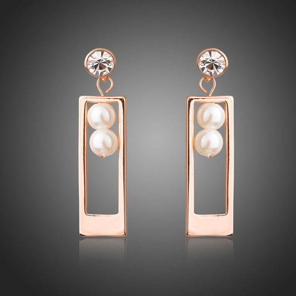 KHAISTA rose gold rectangle pearl drop earrings on white background