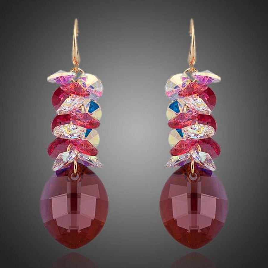 KHAISTA red crystal vine drop earrings on white background