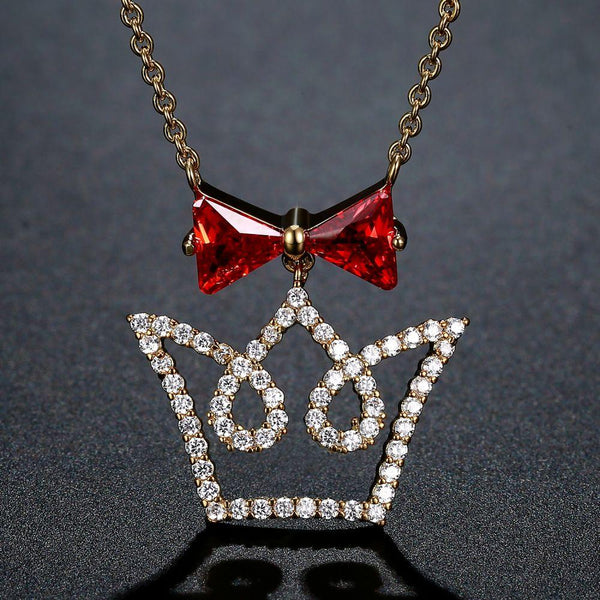 KHAISTA red CZ bow knot crown pendant necklace on white background