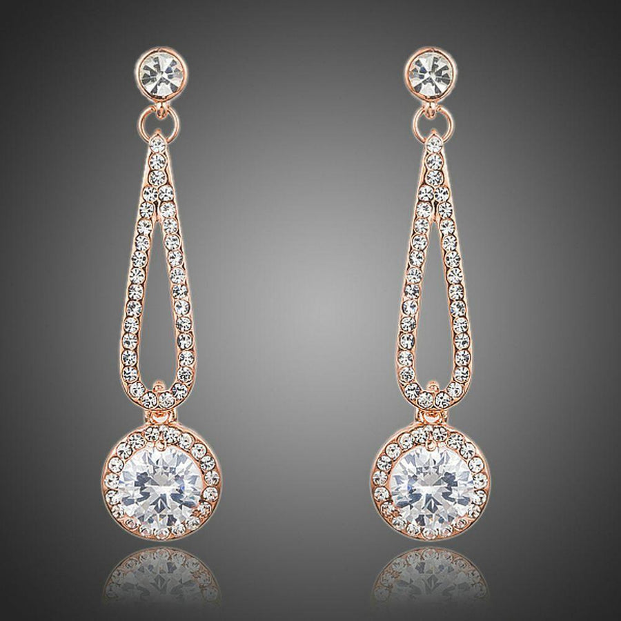 KHAISTA rose gold CZ drop earrings on white background