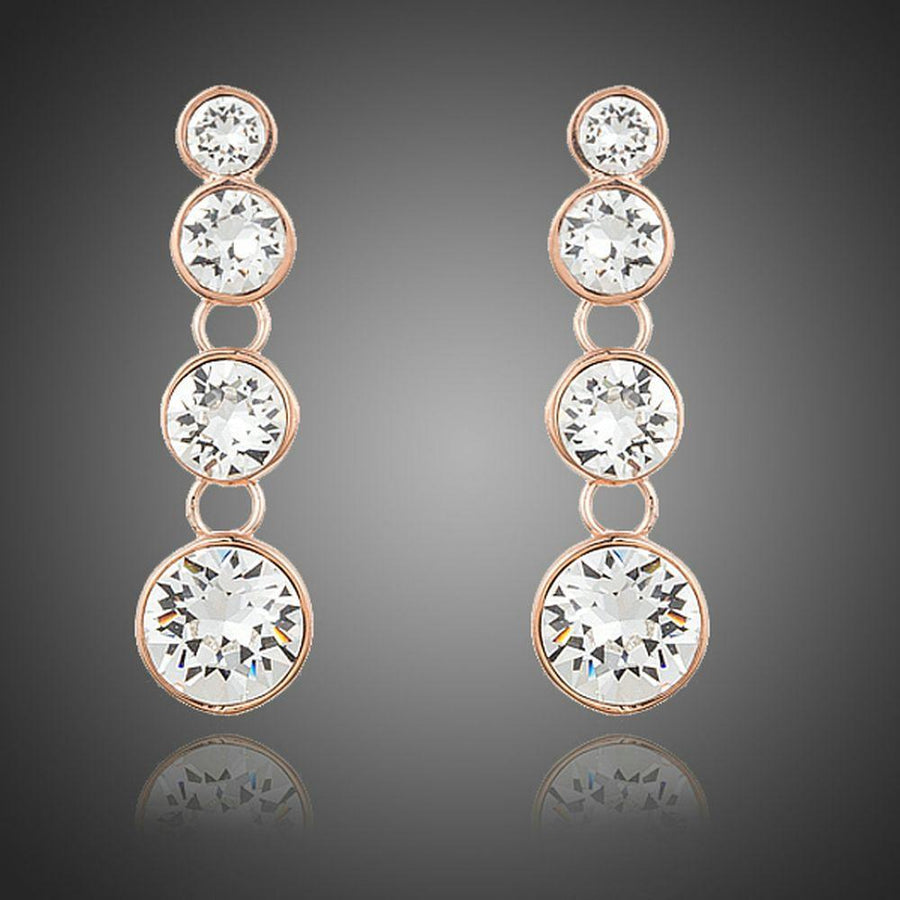 KHAISTA round crystal chain drop earrings on white background
