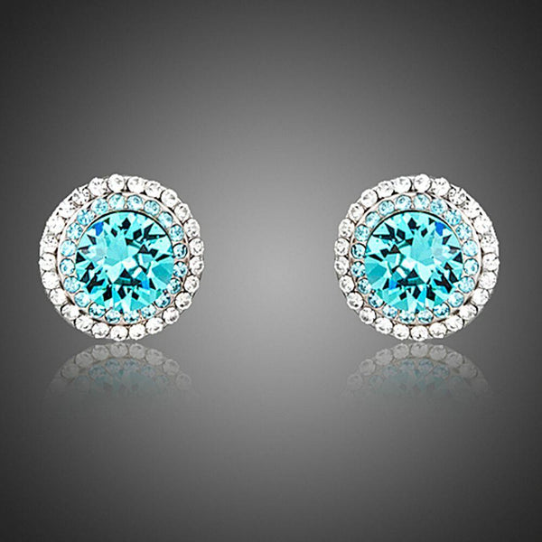 KHAISTA round deep sea crystal stud earrings on white background