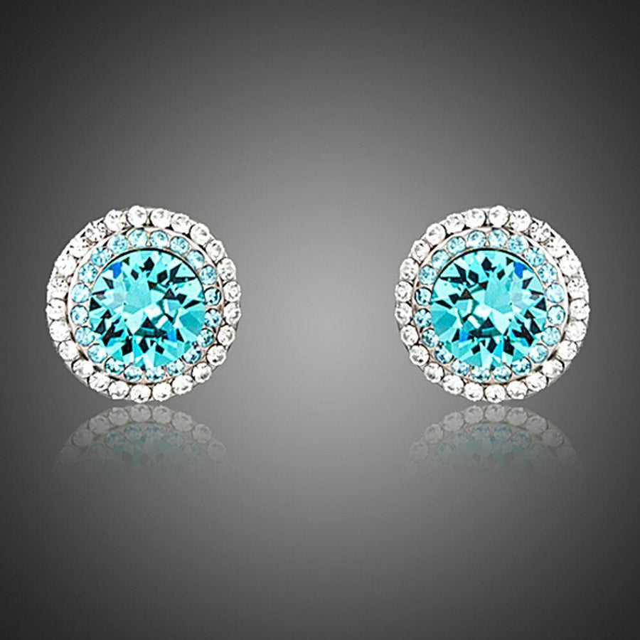 KHAISTA round deep sea crystal stud earrings on white background