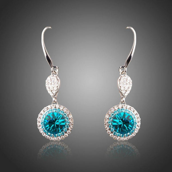 KHAISTA round sea blue crystal hook drop earrings on white background