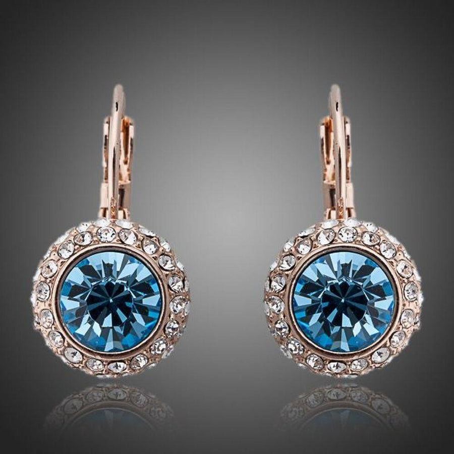KHAISTA sea blue round crystal earrings on white background