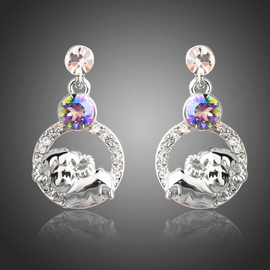 KHAISTA crystal sheep design dangle earrings on white background