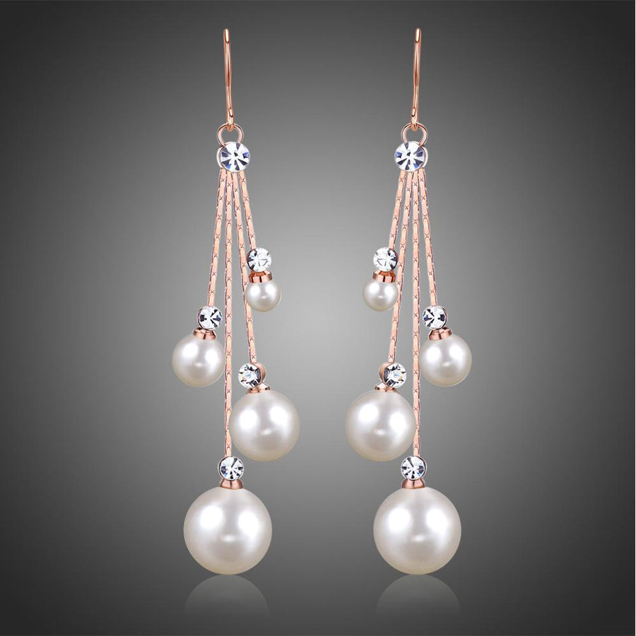 KHAISTA pearl chain dangle hook earrings on white background