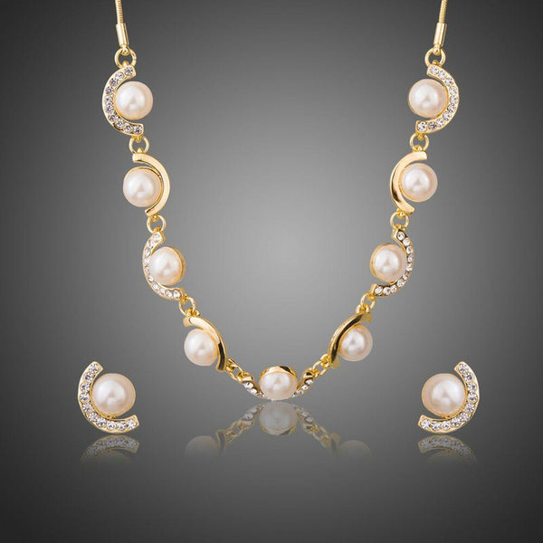 Khaista pearl charm necklace and earrings set on white background