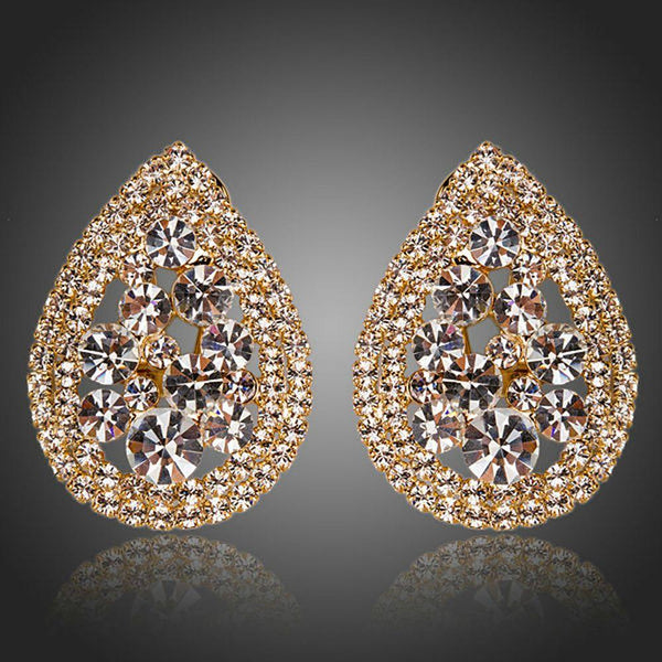 KHAISTA teardrop design crystal stud earrings on white background
