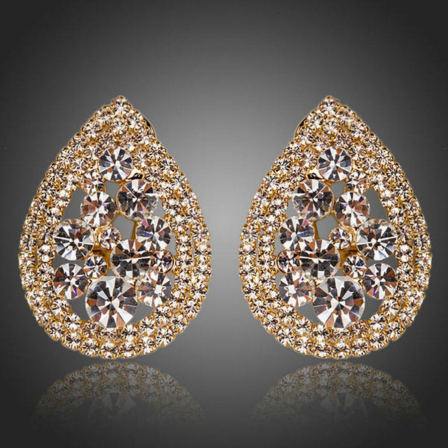 KHAISTA teardrop design crystal stud earrings on white background