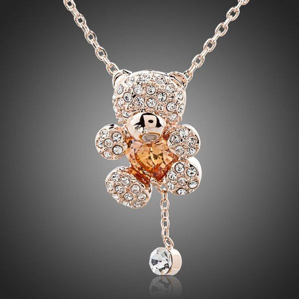 KHAISTA champagne crystal teddy bear necklace on white background