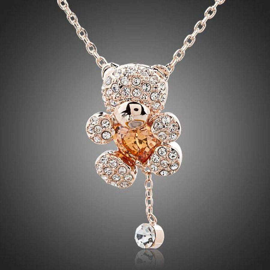 KHAISTA champagne crystal teddy bear necklace on white background