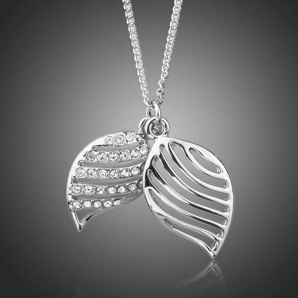 KHAISTA white gold angel wings Stellux crystal necklace on white background