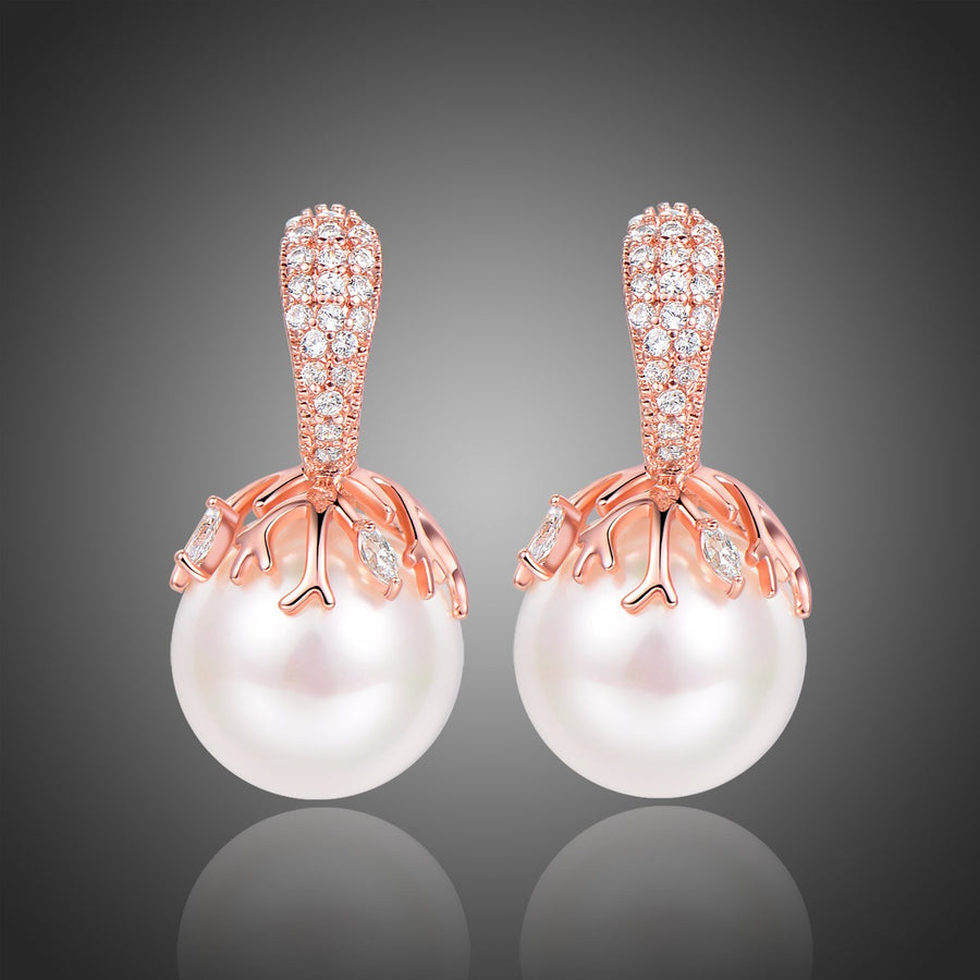 KHAISTA white pearl stud earrings on white background