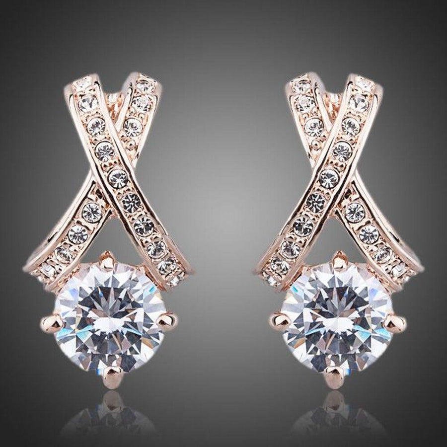 KHAISTA X charm crystal stud earrings on white background