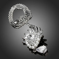 Side angle view of KHAISTA pearl clear waterdrop CZ necklace