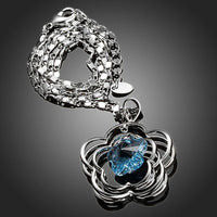 Side angle view of KHAISTA light blue crystal flower necklace