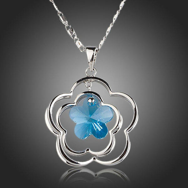 KHAISTA light blue crystal flower necklace on white background