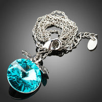Side angle view of KHAISTA sea blue Austrian crystal necklace