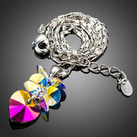 Side angle view of KHAISTA crystal heart pendant necklace