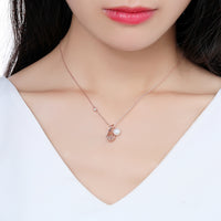 Close up detail of KHAISTA pearl round ball CZ pendant necklace