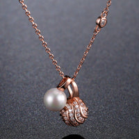 Side angle view of KHAISTA pearl round ball CZ pendant necklace