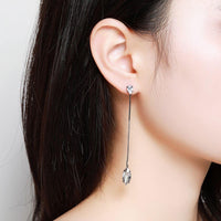 Side angle view of KHAISTA AAA CZ marquise dangle earrings