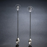 Close up of KHAISTA AAA CZ marquise dangle earrings