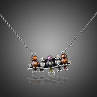 KHAISTA ancient sitting birds crystal necklace on white background