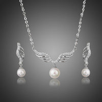 Khaista angel wings pearl necklace earrings set on white background