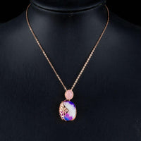 Side angle view of KHAISTA artist paint crystal pendant necklace