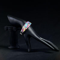 Side angle view of KHAISTA artistic canvas crystal bangle