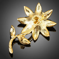 Close-up of gold detail on Khaista artistic flower brooch