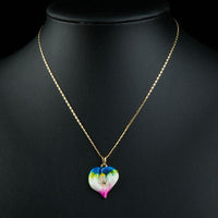 Close up detail of KHAISTA artistic crystal heart pendant necklace