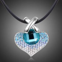 Close up detail of KHAISTA large blue Austrian crystal heart necklace