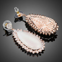 Close up of KHAISTA large opal waterdrop earrings