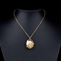 Side angle view of KHAISTA large oval champagne crystal flower necklace