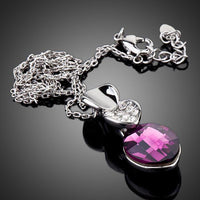 Close up detail of KHAISTA large purple crystal pendant necklace