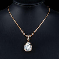 Side angle view of KHAISTA large waterdrop crystal pendant necklace