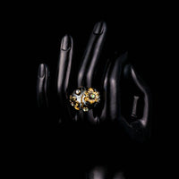 Side angle view highlighting the comfortable band silhouette of the luxury black floral statement ring