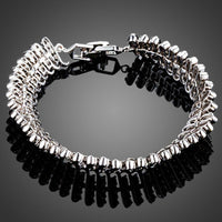 KHAISTA black CZ link chain bangle on white background